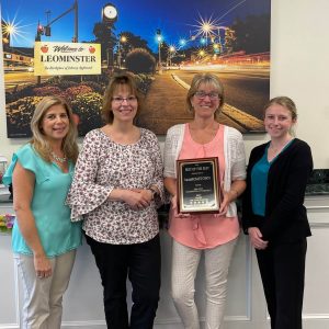 Leominster Office employees holding an award for the best office!