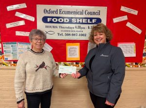 Two women holding a check for the Oxford Ecumenical Council Food Shelf.